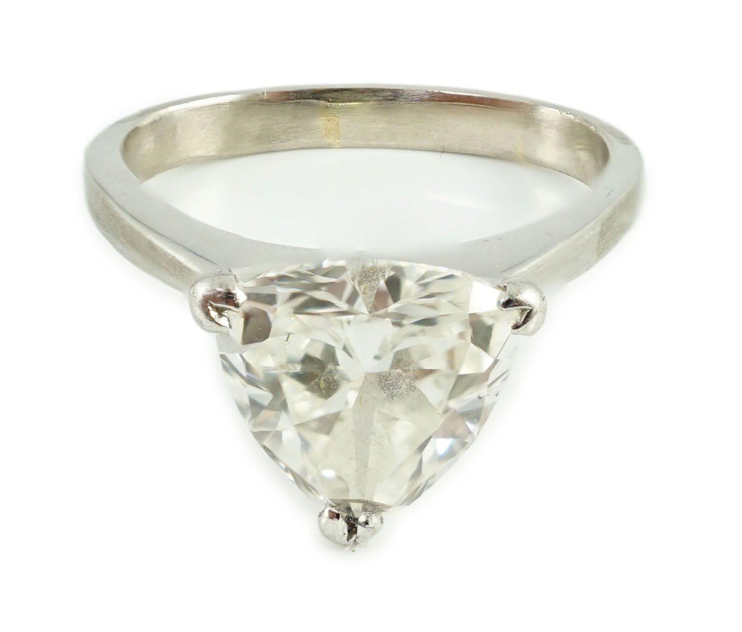 A modern platinum and solitaire trillion cut diamond set ring